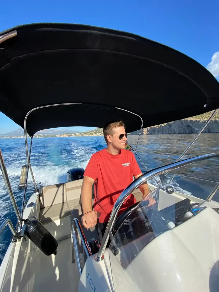 Man steering a Quicksilver boat from the helm while navigating along the Costa Blanca.