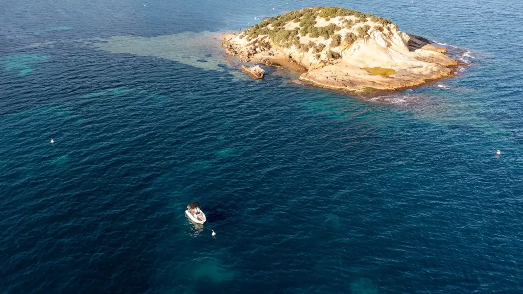 Boat moored to a buoy at La Olla Island in Altea, a regulated anchoring area ideal for snorkeling
