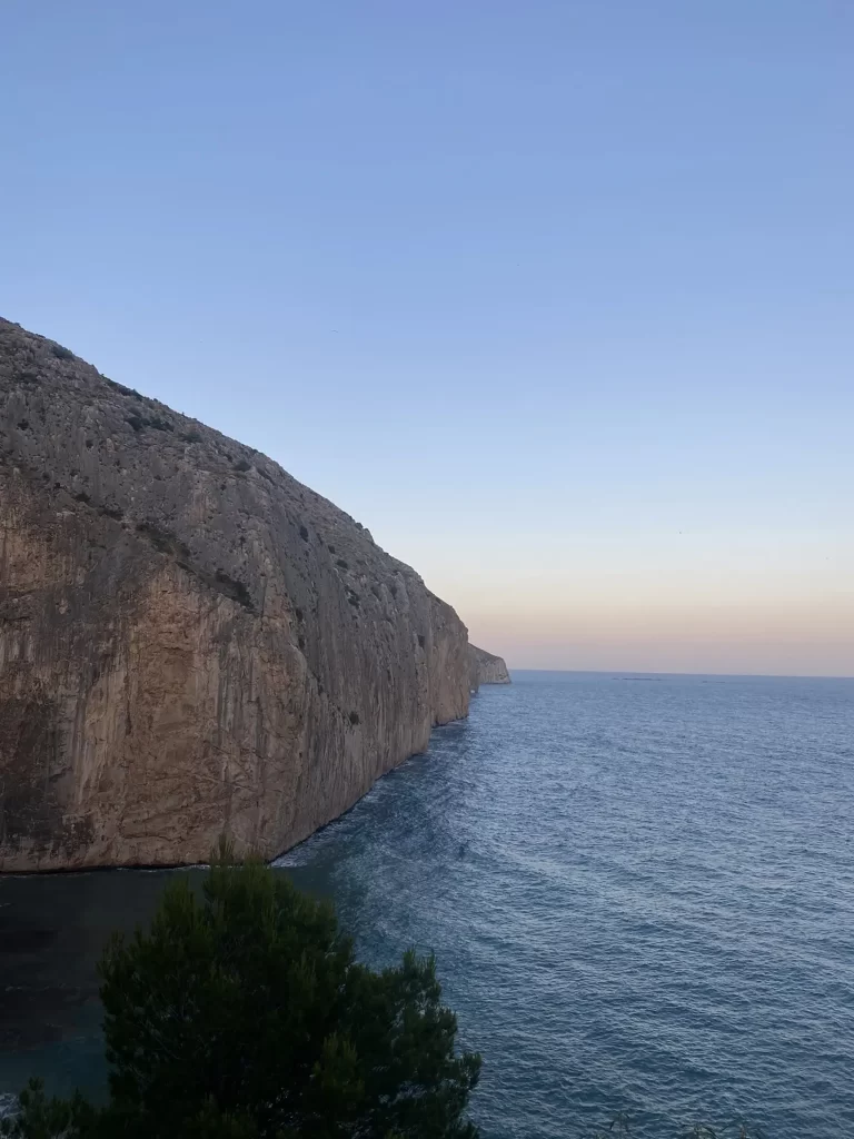 Mascarat cliffs glowing in the golden sunset light on the Costa Blanca.