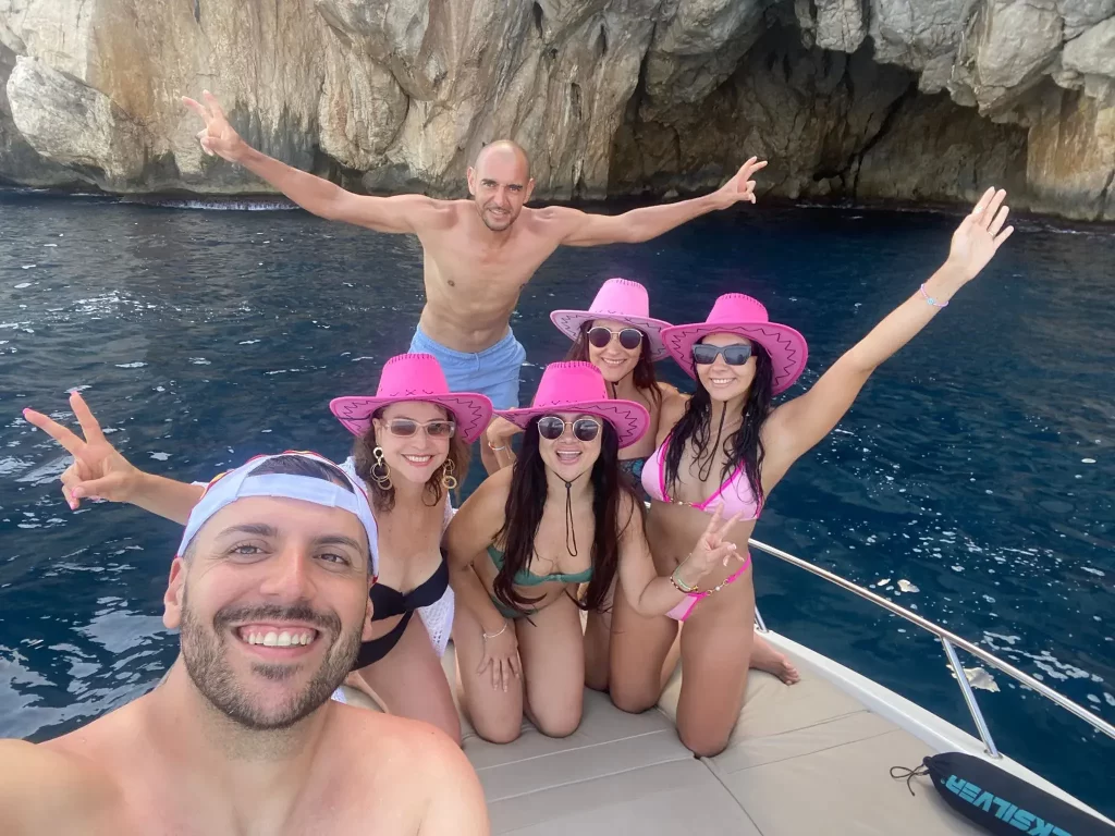 Group of friends relaxing on the bow sunbed of a Quicksilver 675 Sundeck while navigating near the caves of Mascarat on the Costa Blanca.