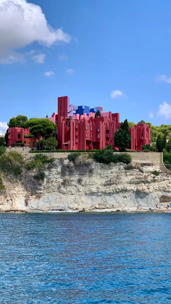 View of La Muralla Roja in Calpe, iconic red building designed by Ricardo Bofill on the Costa Blanca