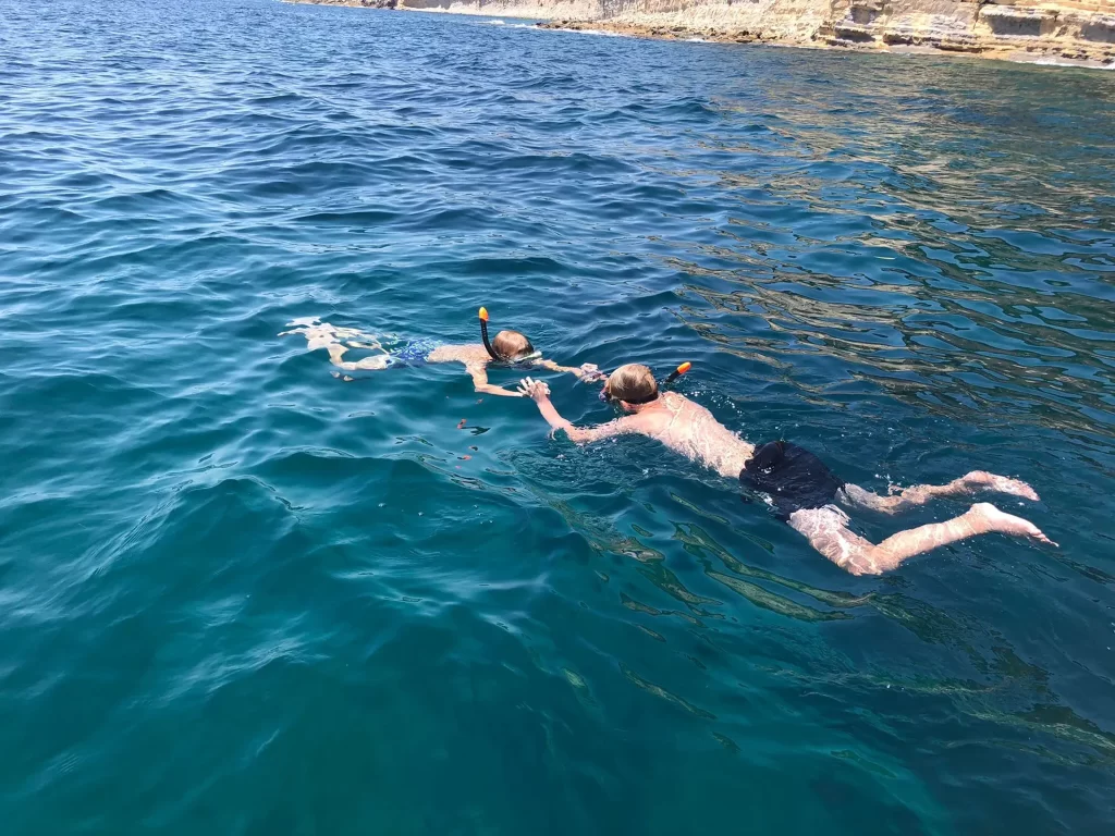 Father and son snorkeling in the transparent waters of the Costa Blanca during a boat trip from Altea.