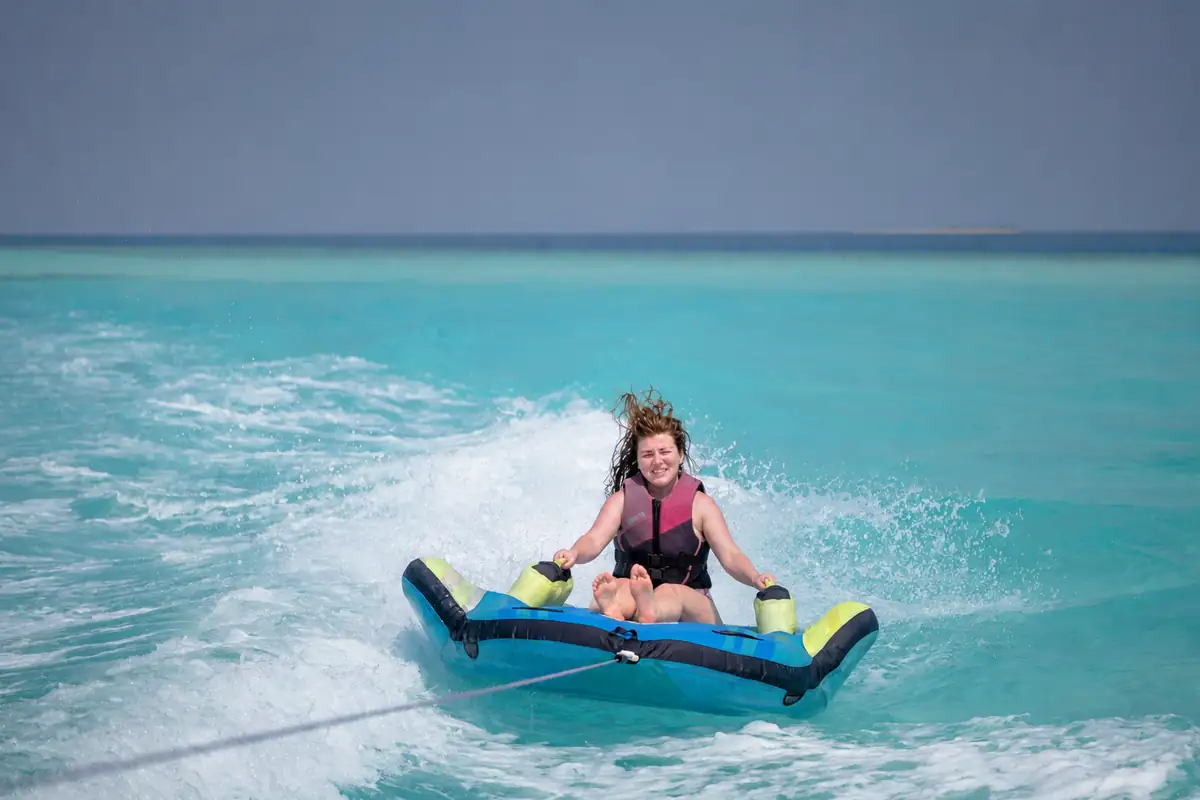 Woman on towable donut with safety jacket - water activities Altea Costa Blanca